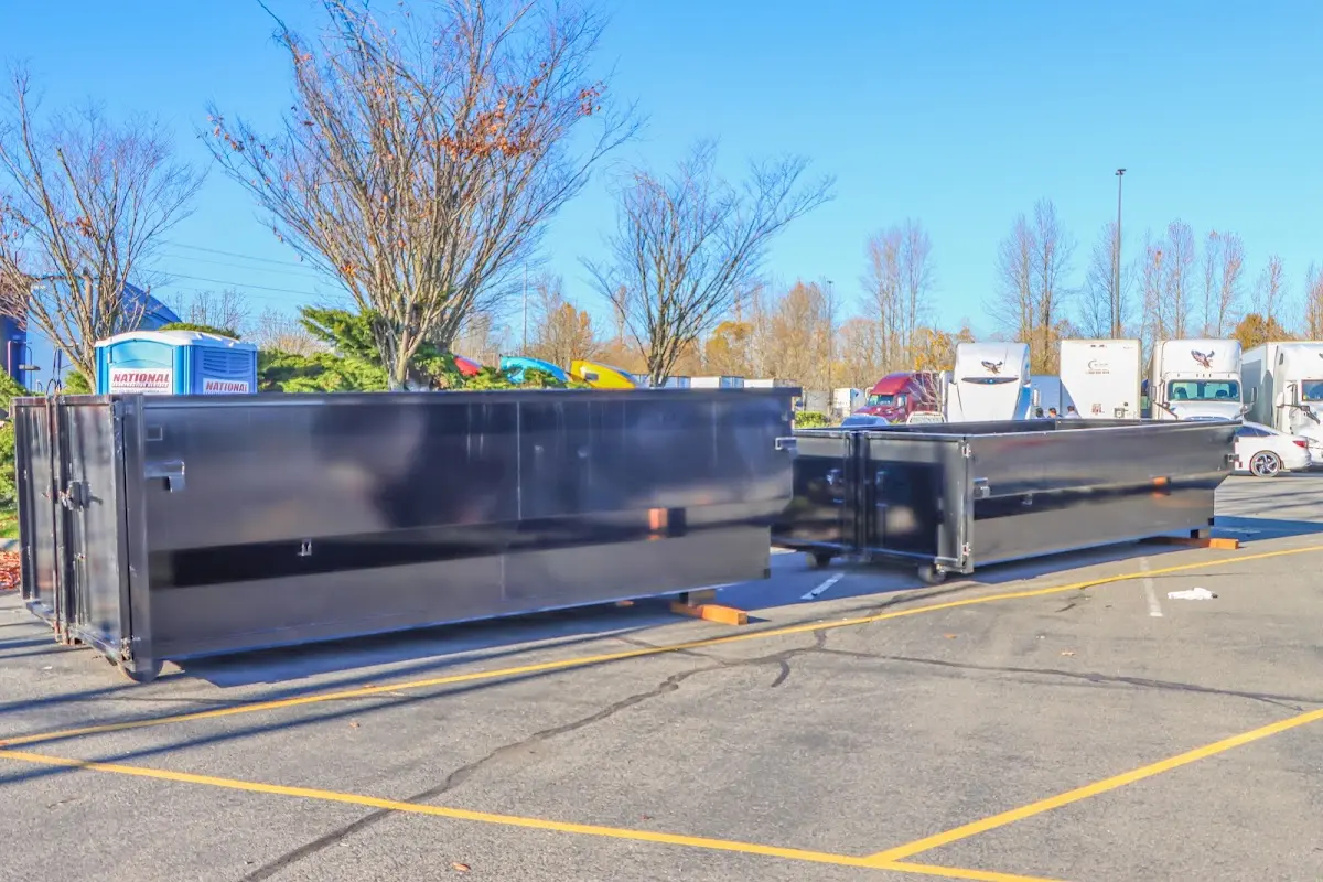 Professional dumpster rental service with roll-off container on residential driveway in North Riverside